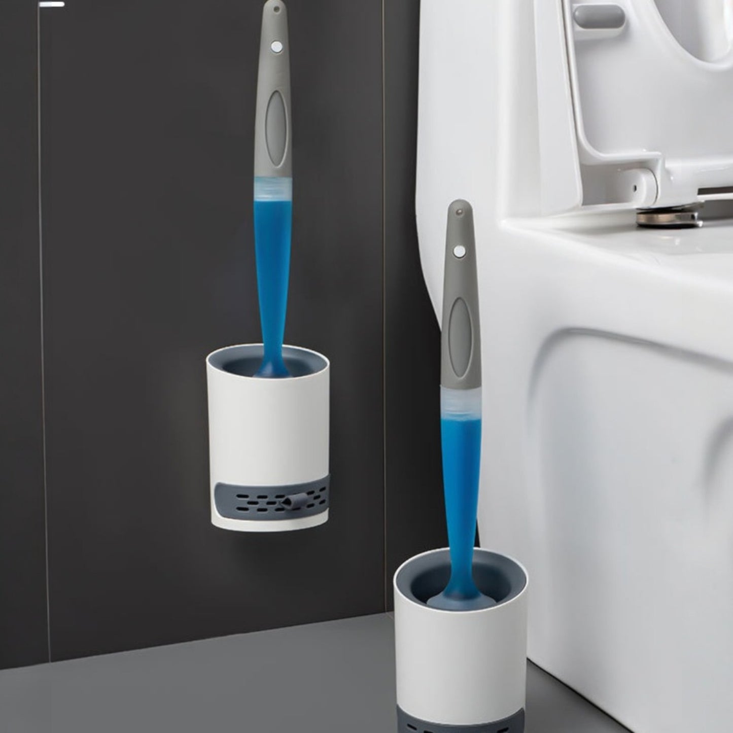 Two toilet cleaning brushes with blue bristles in white holders against a bathroom background.