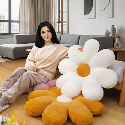 Woman sitting on a couch with a large flower-shaped pillow in a modern living room.