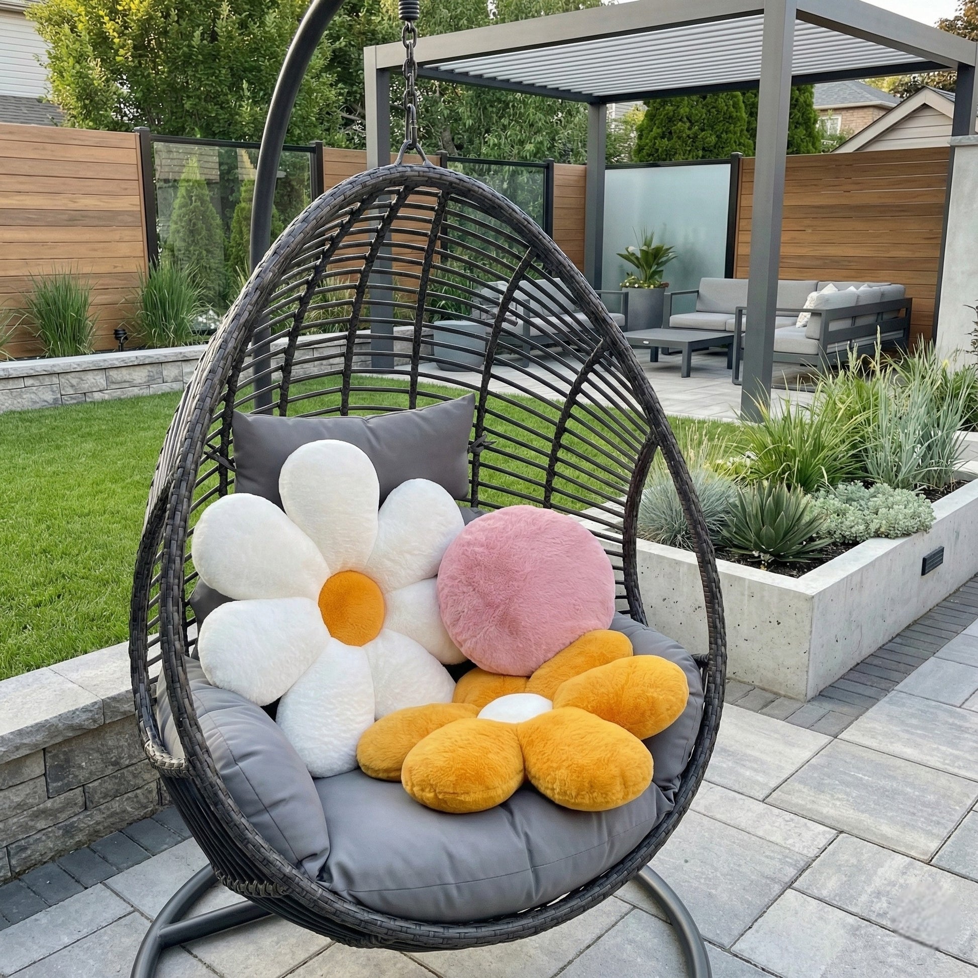 Hanging chair with floral cushions in a garden setting