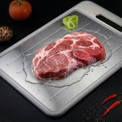 Raw steak on a metal tray with vegetables on a dark background