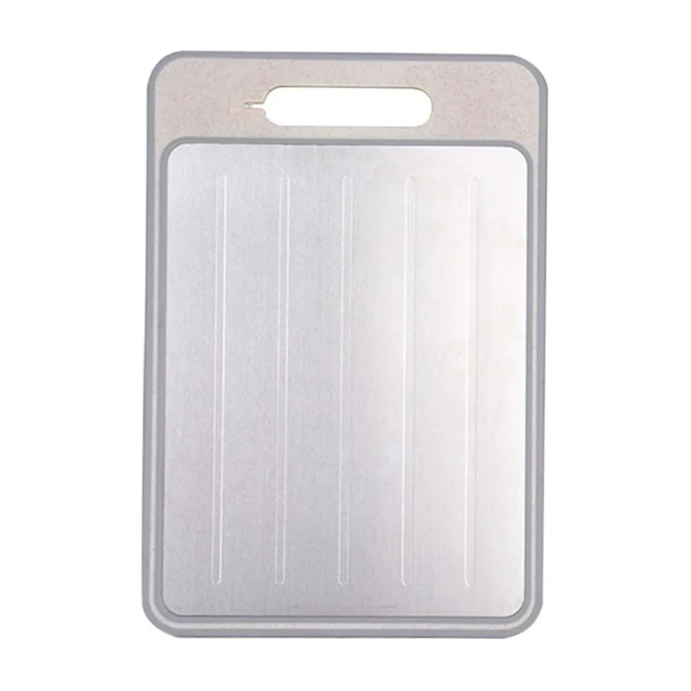 A rectangular stainless steel cutting board with a built-in handle cutout at the top and four vertical ribbed indentations on the front, shown against a plain white background.