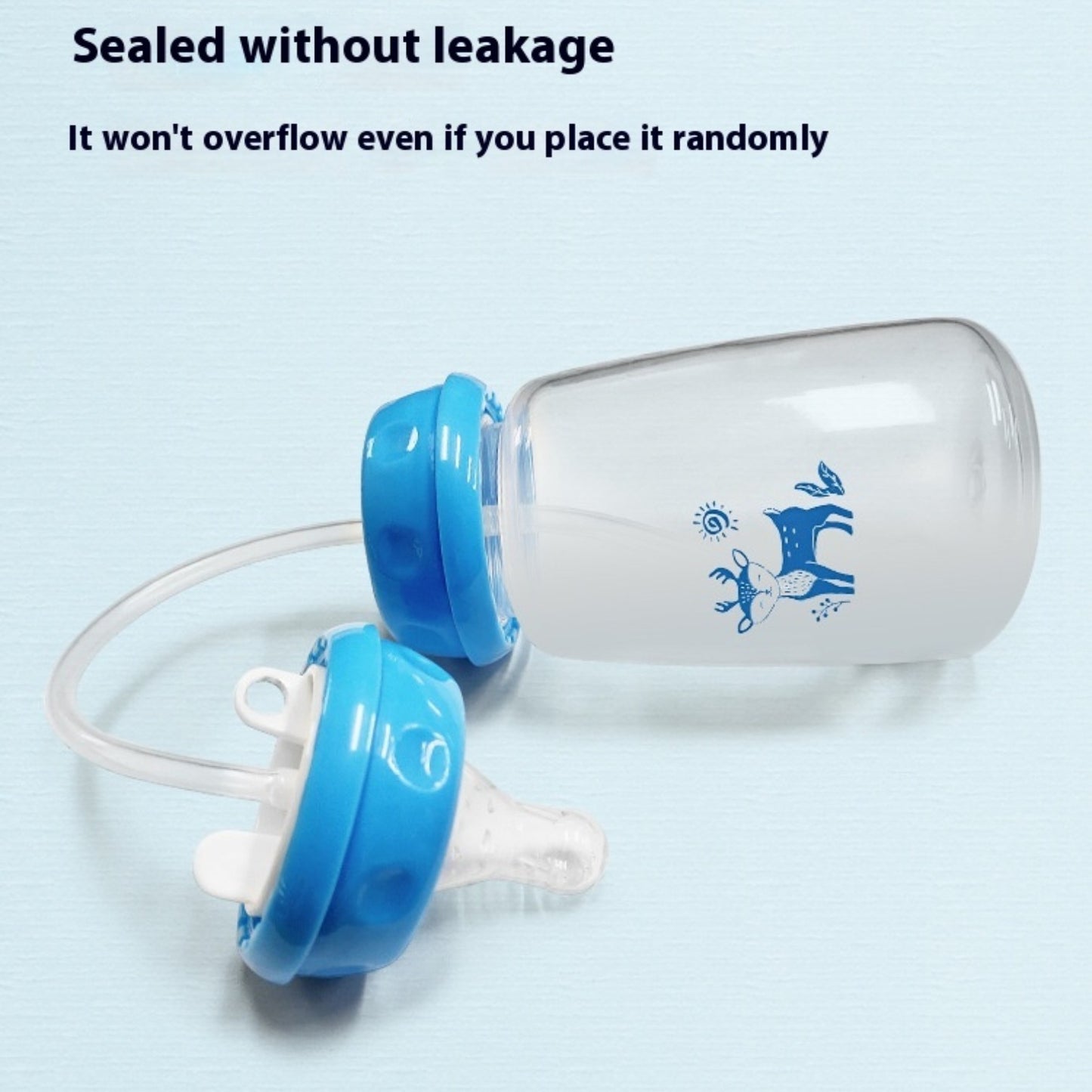 Baby bottle with blue cap on a light blue background