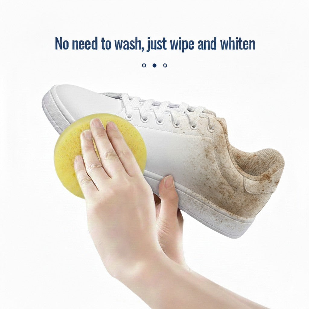 Person cleaning a white shoe with a yellow cleaning ball on a white background