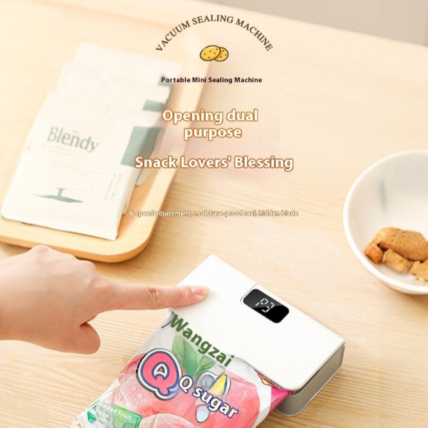 Vacuum sealing machine on a table with snacks and a book