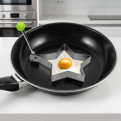 Star-shaped egg mold in a frying pan on a kitchen counter