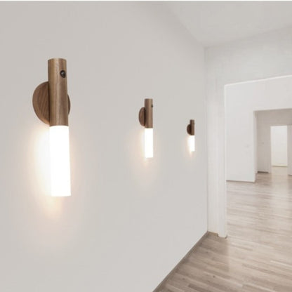 Wooden wall sconces on a white wall with a minimalistic interior design.