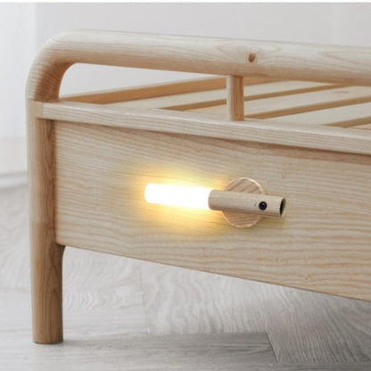 Wooden nightstand with a built-in light on a white background