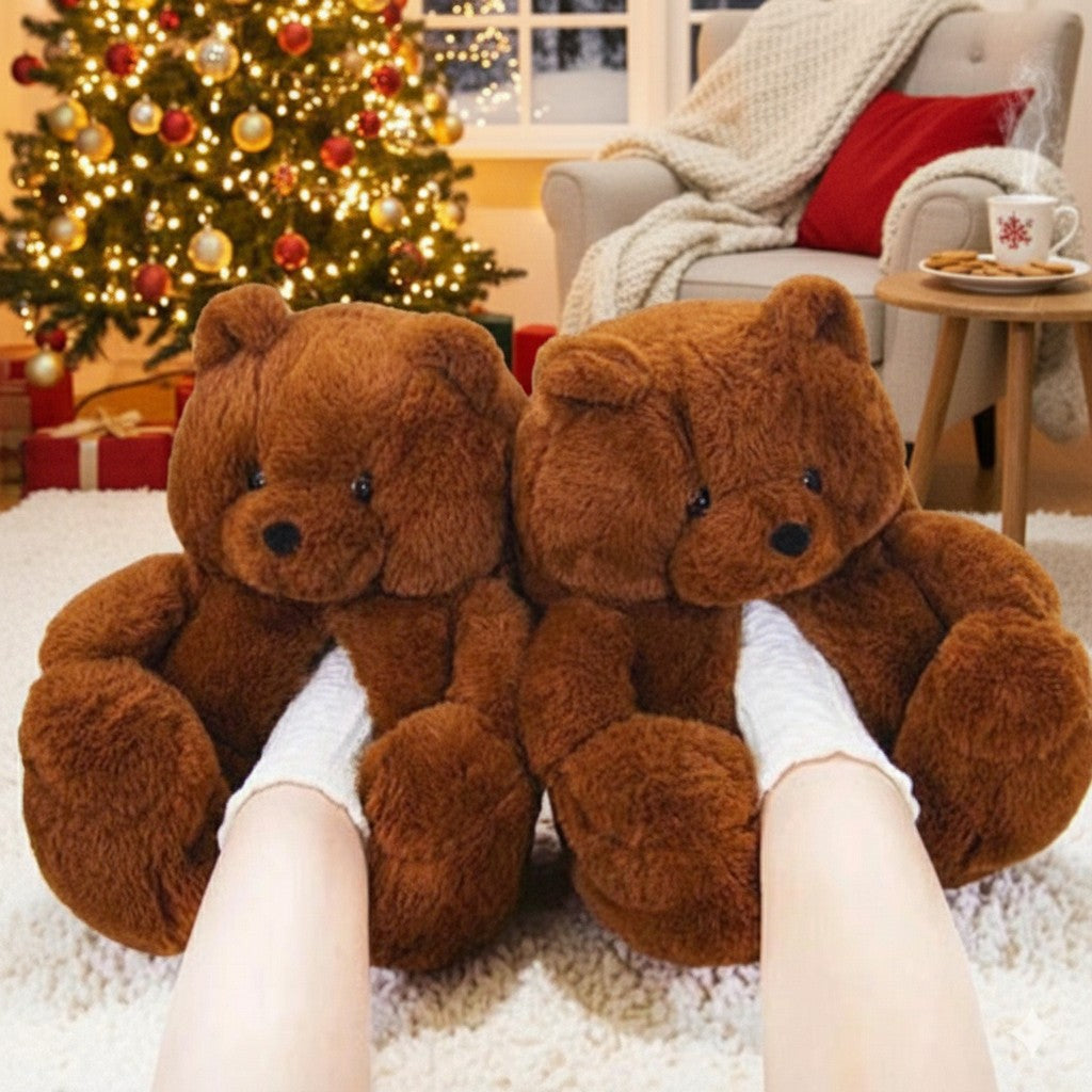 Two large brown teddy bears worn as slippers with a Christmas tree and decorations in the background.