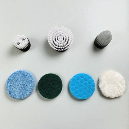 Set of various cleaning brushes and sponges on a light gray background