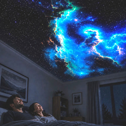 Couple in bed looking up at a starry night sky projected onto the ceiling.