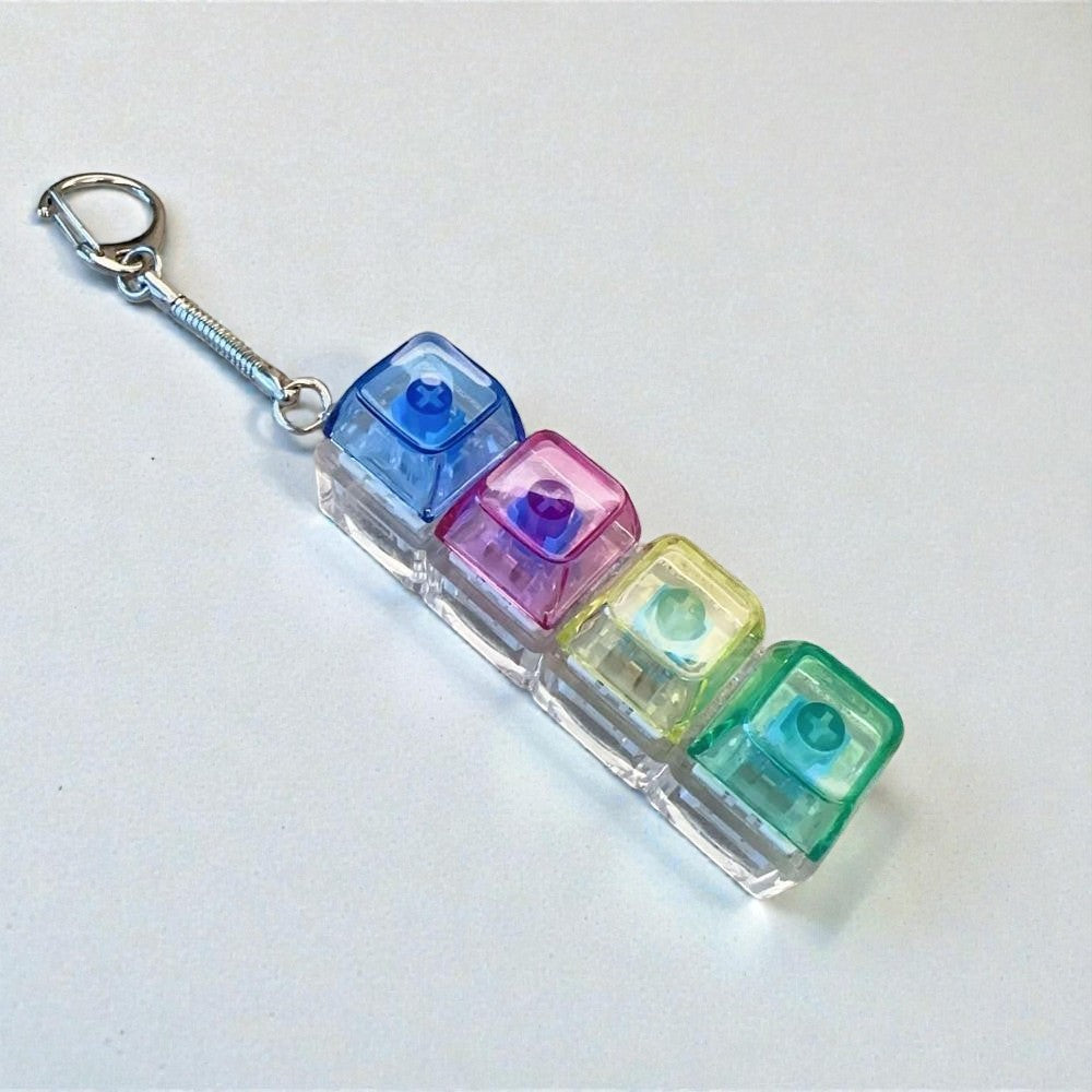 Colorful keychain with four transparent cubes on a white background