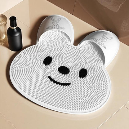 White bear-shaped mat with black eyes and mouth on a beige floor.