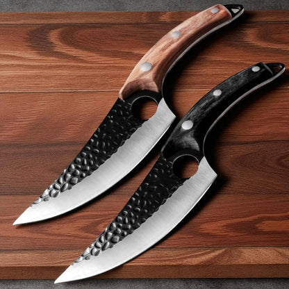 Two curved kitchen knives with hammered steel blades and different handle finishes, displayed diagonally on a dark wood background.