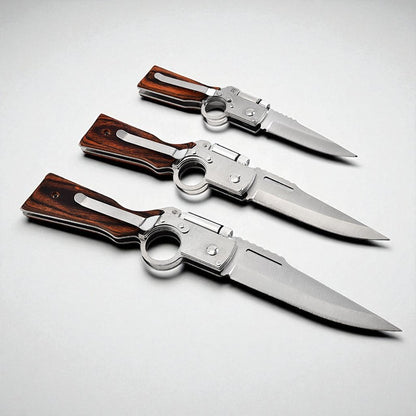 Three folding knives with wooden handles on a light gray background