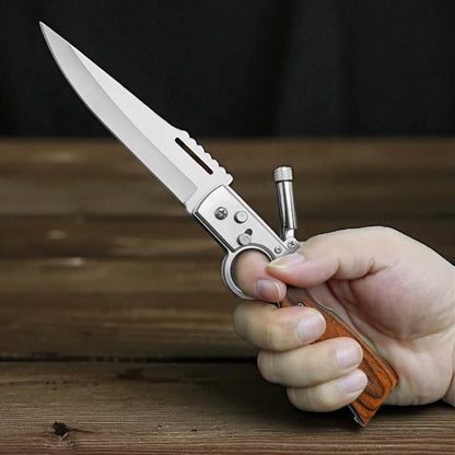 Hand holding a folding knife with a wooden handle on a wooden surface