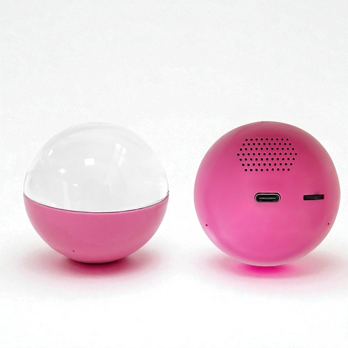 Two pink spherical  VIDEO PLAYER BALL, one transparent and one with a speaker grille, on a white background.