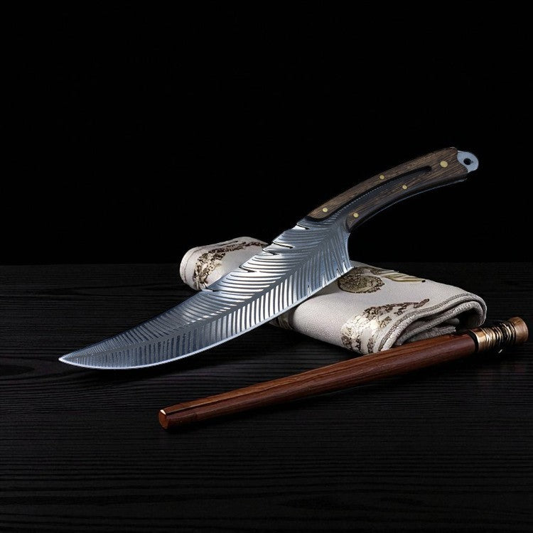 Forked knife with decorative sheath on a dark surface