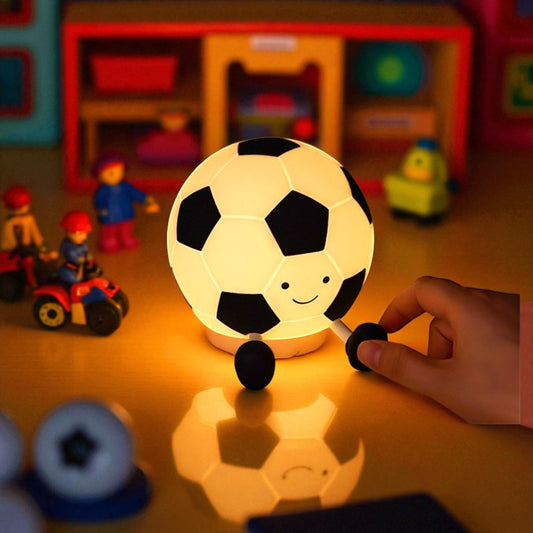 Children's room with a soccer ball-shaped night light and toys in the background