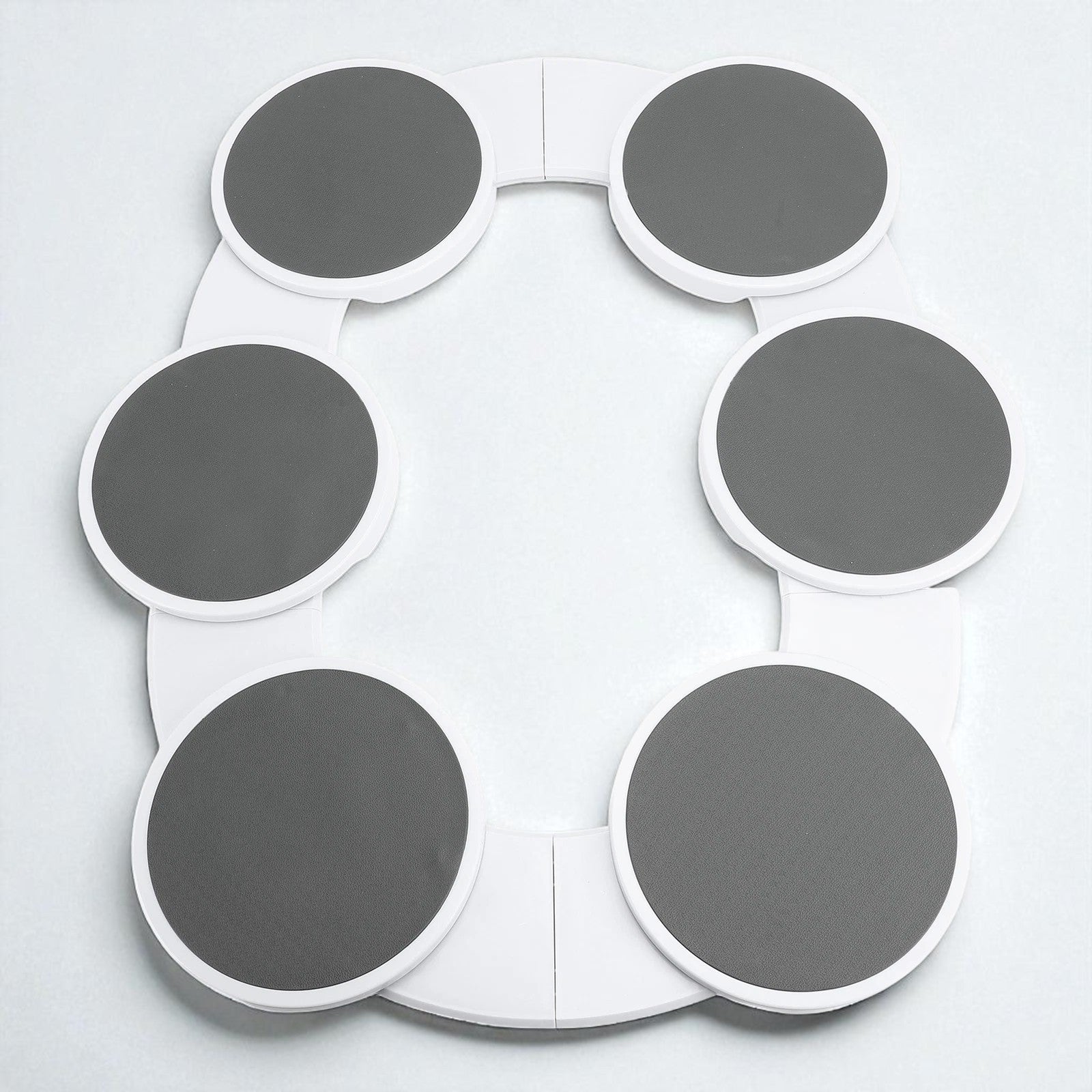 Circular object with gray and white sections on a light gray background