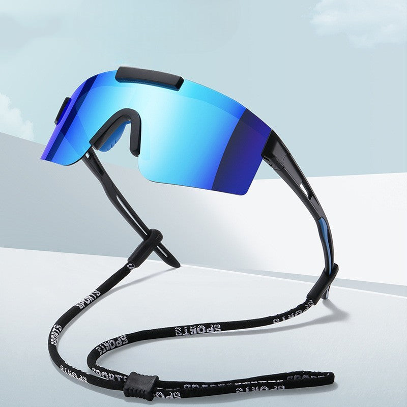 Sunglasses with a blue lens and black frame on a light gray background