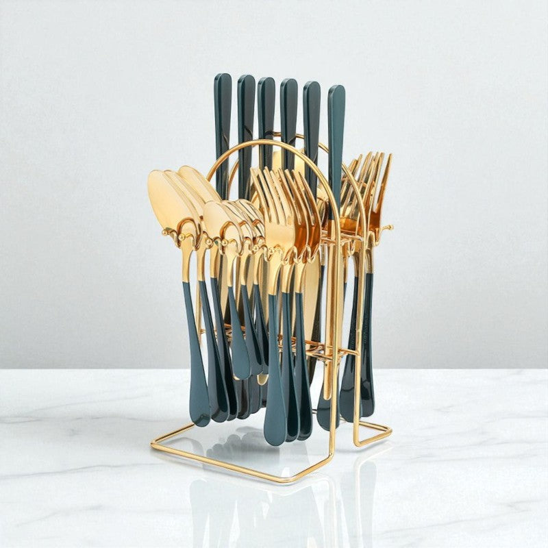 Set of gold and green cutlery in a stand on a white background