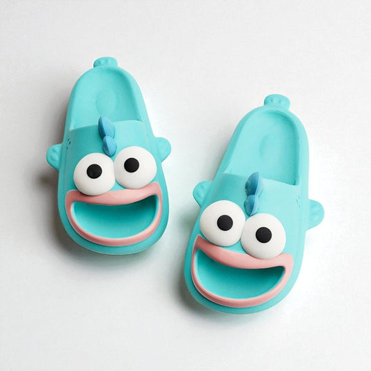Pair of blue children's sandals with cartoon face design on a white background